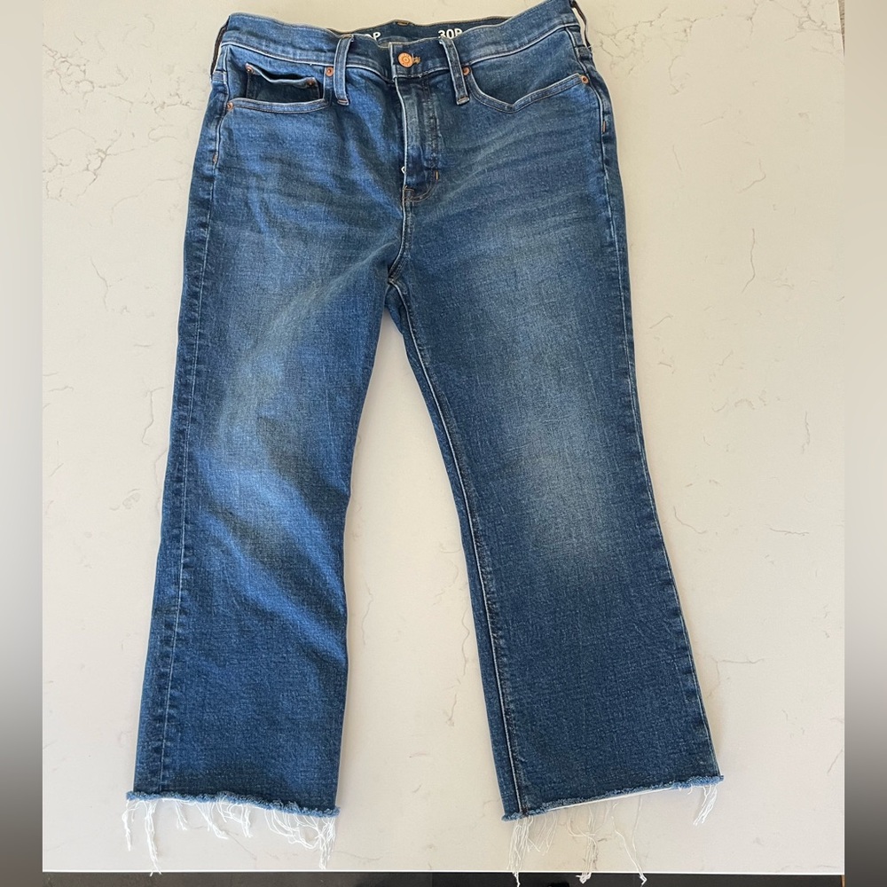Blue Flare Jeans with Raw Hem and Subtle Fading
